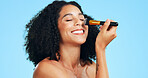 Happy, makeup and woman with brush in studio for cosmetics, application and makeover. Cosmetology, space and person laugh with tools for change, beauty products and salon aesthetic on blue background