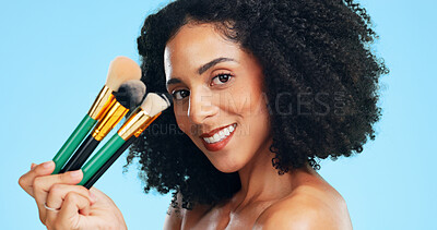 Buy stock photo Makeup, brushes and portrait of woman in studio for cosmetics, application and foundation. Cosmetology, happy and person with tools for blush, beauty products and salon aesthetic on blue background