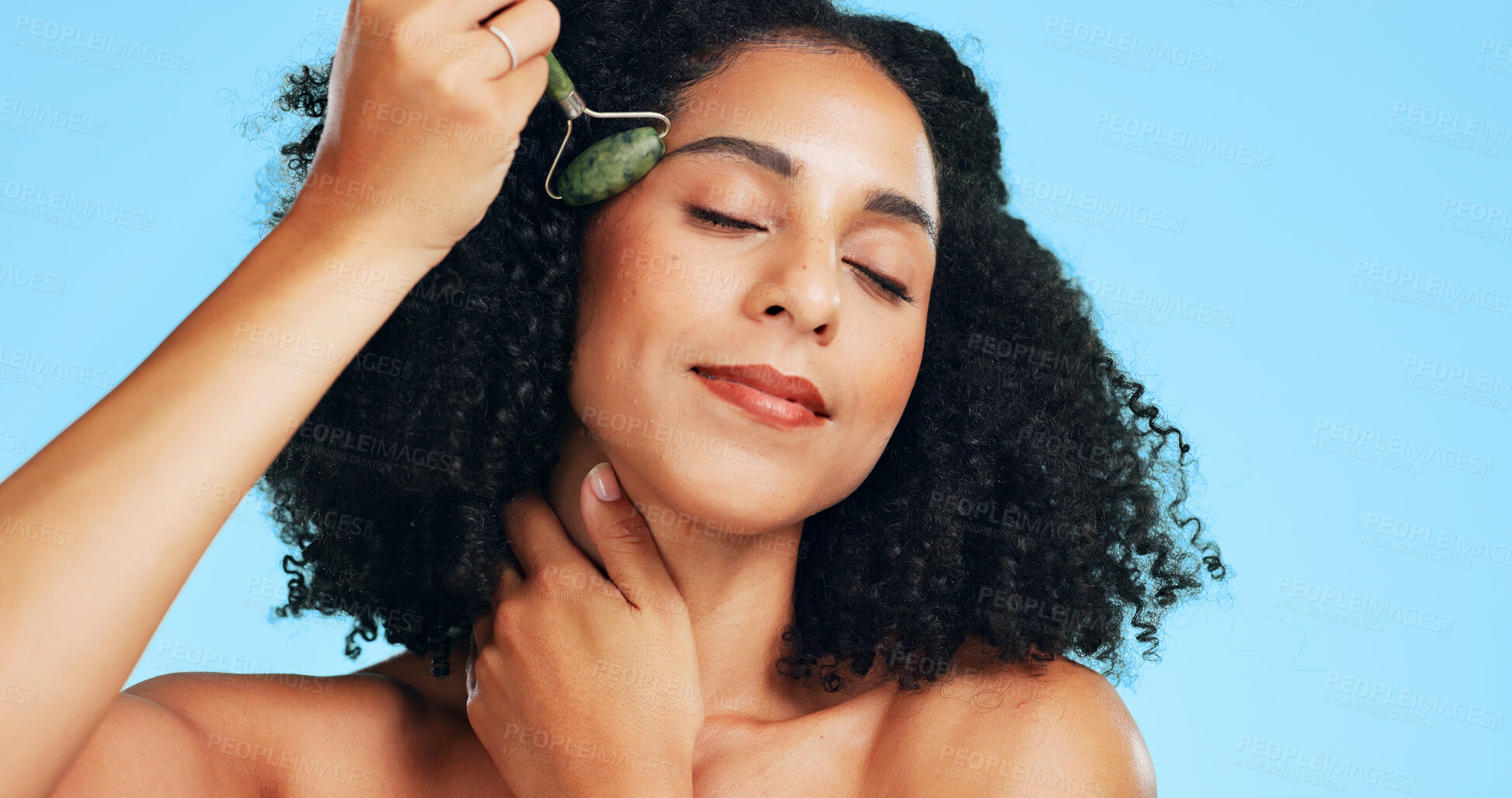 Buy stock photo Studio, beauty and woman with roller for skincare, wellness and dermatology for anti aging benefits. Blue background, facial massage and happy person with tool for healthy skin, cosmetic or self care