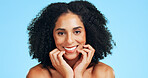Skincare, happy or woman in studio with portrait, shine or soft touch in facial care. Wellness, smile or female person on blue background with confidence, dermatology or glow with for smooth skin.