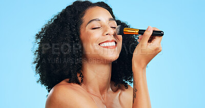 Buy stock photo Beauty, smile or woman in studio with brush, coverage or blending in makeup routine. Cosmetology, happy or person on blue background with tools, makeover preparation or flawless application for glow.