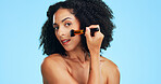 Beauty, portrait or woman in studio with brush, coverage or blending in makeup routine. Cosmetology, space or female person on blue background with tools, makeover or flawless application for glow.