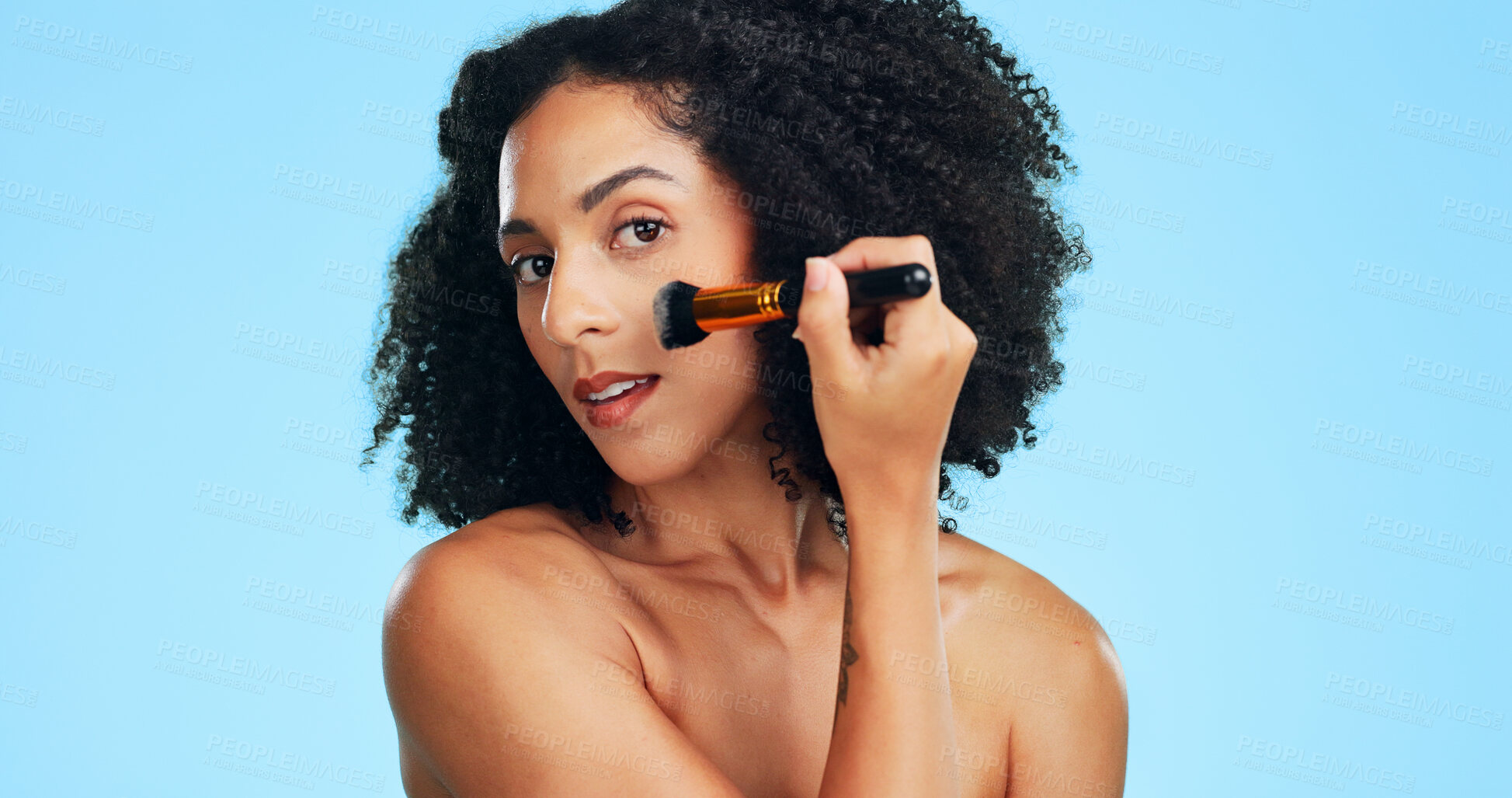 Buy stock photo Beauty, portrait or woman in studio with brush, coverage or blending in makeup routine. Cosmetology, space or female person on blue background with tools, makeover or flawless application for glow.