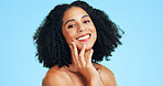 Portrait, skincare and woman in studio for natural glow, beauty and wellness on blue background. Cosmetic, touch face and happy person with aesthetic, dermatology or self care with healthy skin