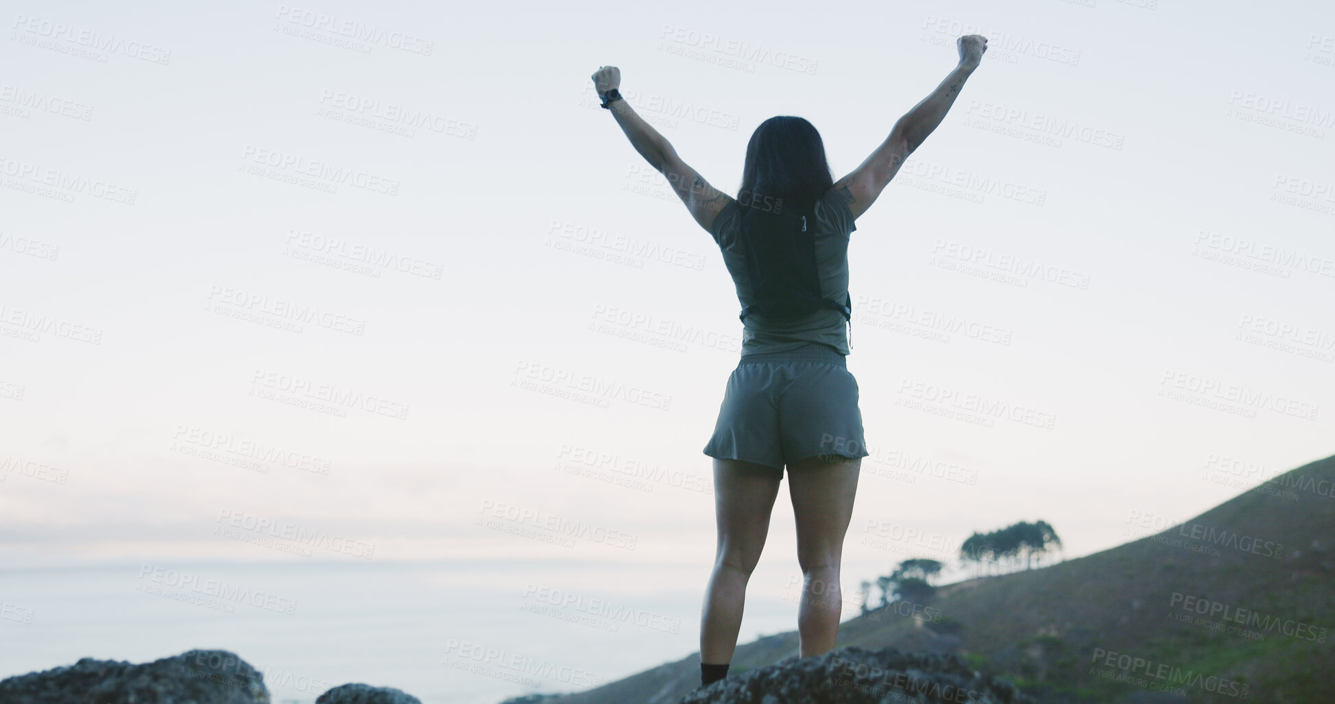 Buy stock photo Hike, back and woman on cliff with arms up, cardio goal or celebration in fitness activity. Training, space or person on mountain with victory, achievement and milestone reach in outdoor trekking.