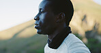 Man, thinking and hiking on mountain with break, fitness and tourist exploration outdoor for weekend. Space, black person relax and reflection in nature with adventure, wellness and sightseeing trip.