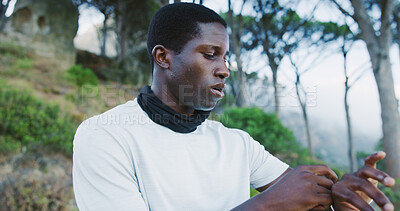 Buy stock photo Smart watch, fitness and black man on mountain for hiking, exercise or sports tracking in nature. Outdoor, active and African male person with accessory for trekking health or wellness with cardio.