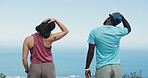 Back, hiking and interracial couple with stretching for fitness, trekking or adventure with mountain trail. Outdoor, hiker or people with warm up for travel, exercise or holiday and explore nature