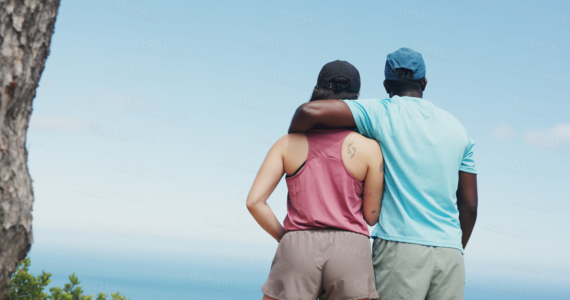 Buy stock photo Back, hiking and interracial couple with hug for fitness, trekking or adventure with space. Outdoor, hiker or people with view for travel, exercise or holiday and explore nature with blue sky