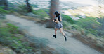 Exercise, woman and running in forest with motion blur, body wellness and cardio endurance with speed. Person, outdoor and fast runner in woods for fitness, training practice and workout challenge