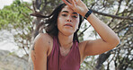 Fitness, break or runner in nature with portrait, cardio fatigue or rest in outdoor practice. Exercise, bokeh or woman in forest with sweating, training pause and recovery for performance goals.