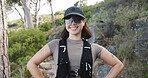 Hiking, break and happy woman with glasses in woods, hobby or travel with hydration vest on holiday. Hiker, smile and person with eyewear in nature, vacation and outdoor for adventure in Canada