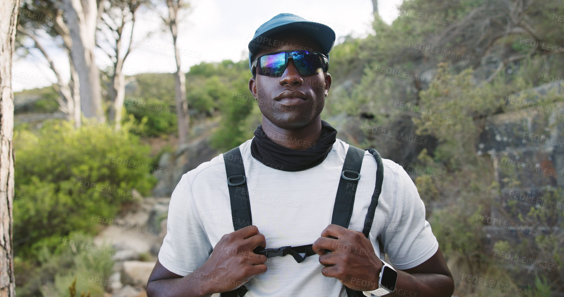 Buy stock photo Outdoor, hiking and man with sunglasses in woods, wellness and serious with hydration vest on trip. Hiker, portrait and black person with eyewear in nature, travel and pride for exploration in Kenya