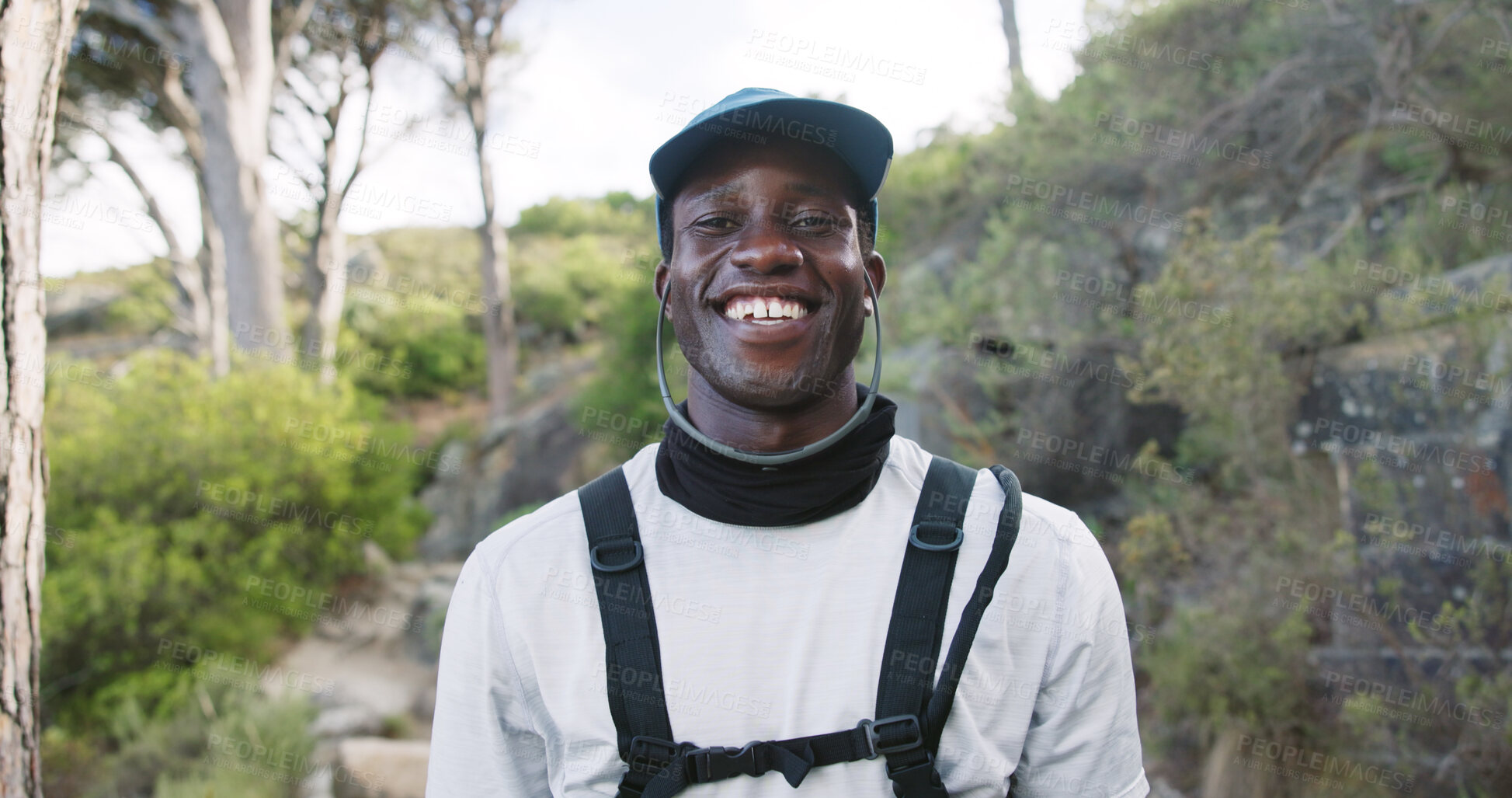 Buy stock photo Portrait, hiking and happy man with hobby in woods, outdoor and travel with hydration vest in nature. Hiker, exploring and black person with smile on getaway, break or vacation for wellness in Kenya