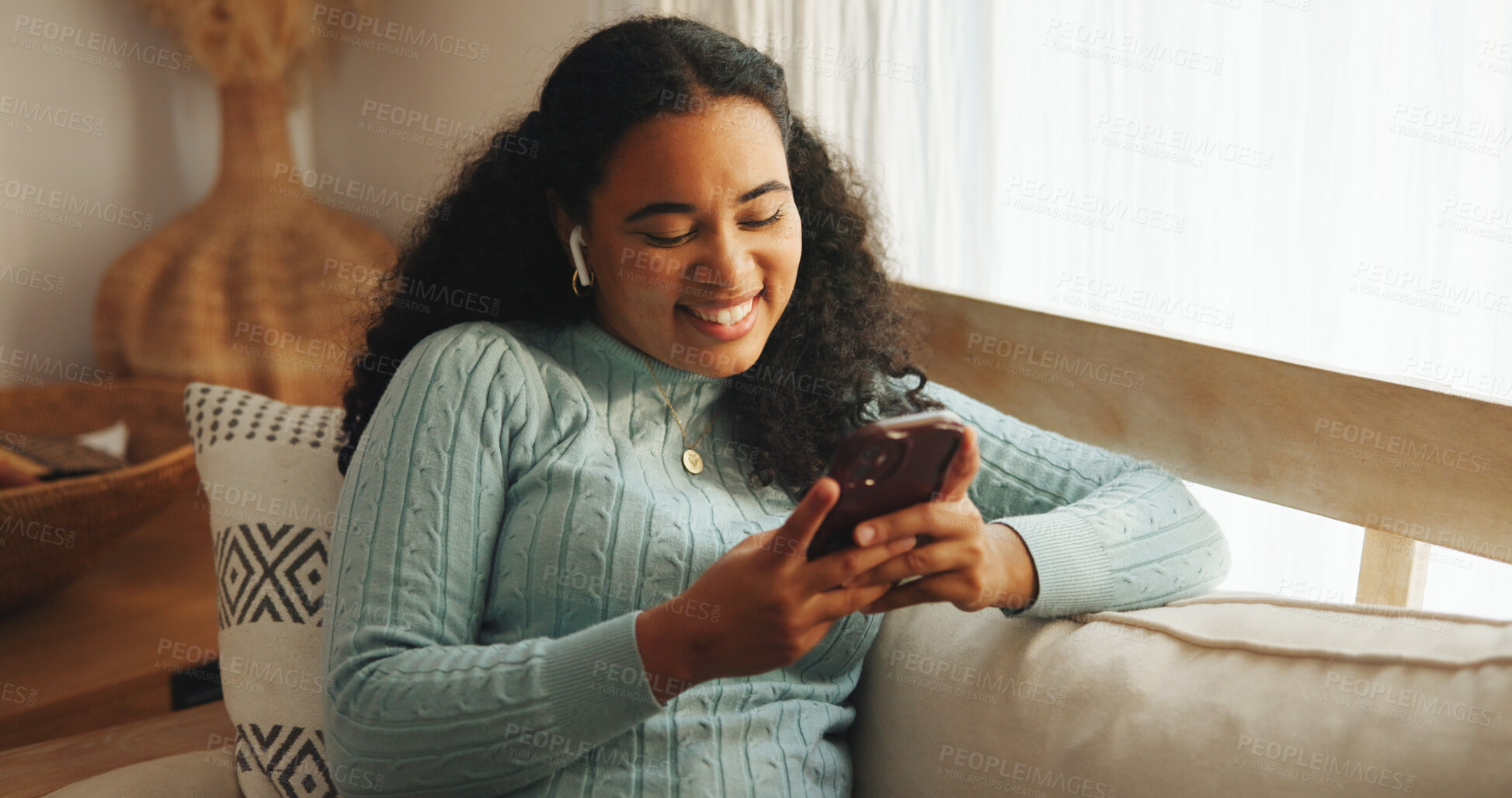 Buy stock photo Woman, phone and online comedy in home with earphones, laughing and relax with chat on social media. Meme, texting or female person with website joke, humor blog or podcast with happiness in lounge