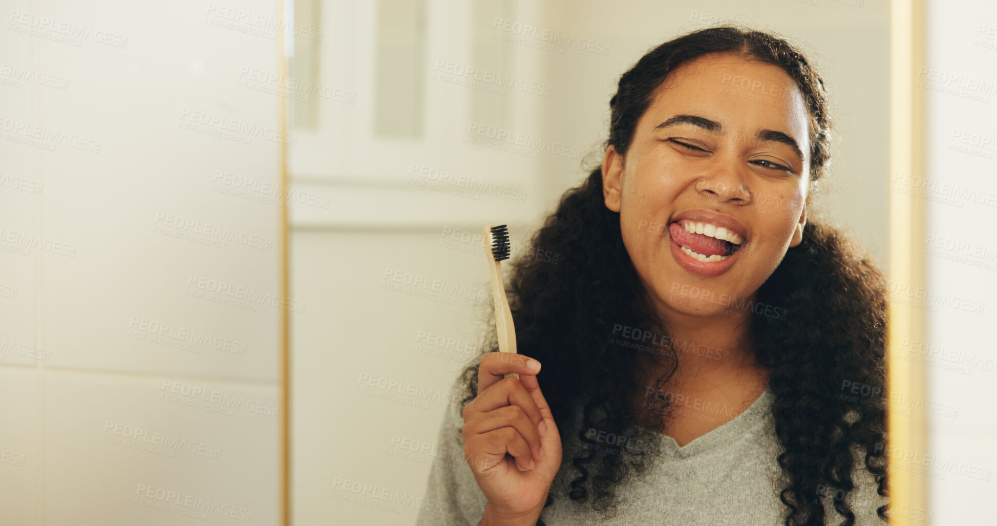 Buy stock photo Mirror, toothbrush and woman in bathroom with wink for dental hygiene, oral wellness and natural. Bamboo, tongue out and happy person brushing teeth, eco friendly or cleaning with reflection in house