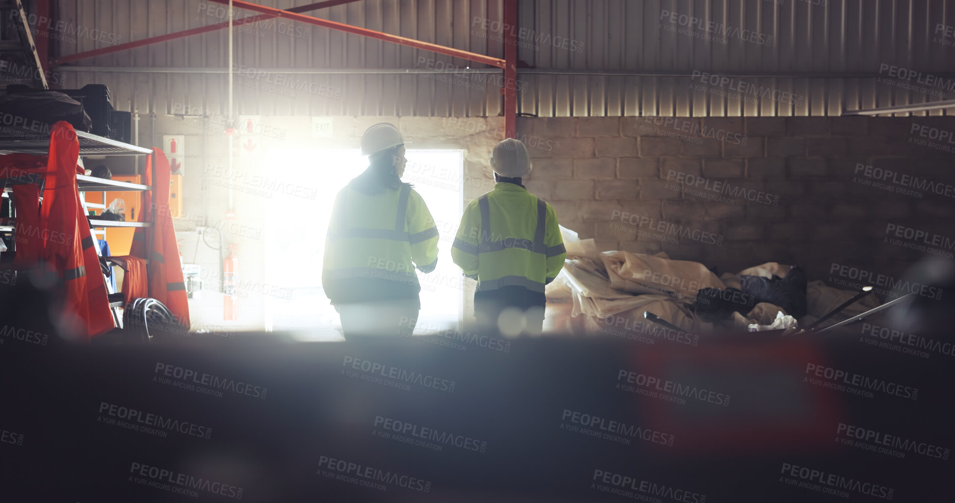 Buy stock photo People, civil engineer and warehouse with team for construction, building or renovation. Back view, employees or contractors with hard hat on site for industrial architecture, safety or maintenance