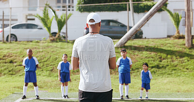 Buy stock photo Outdoor, children or man with coaching for soccer, sports training or instructions for practice match. Fitness, team game or coach with kids for skill development, field or explain football exercise