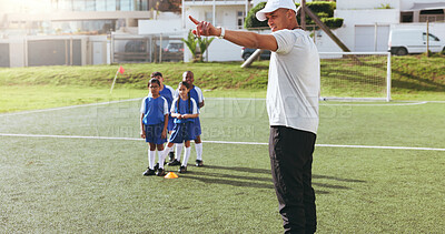 Buy stock photo Coach, team and kids on field for soccer, practice and help with game play or pointing. Man, children and football match training for exercise, youth athlete group and fitness outdoor at pitch