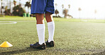 Fitness, legs and child on field for soccer match, training or exercise outdoor for competition. Active, grass and kid athlete by cone for football practice, workout or game with sports for health.