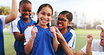 Football field, team and girl with smile for win, laughing or celebration for challenge achievement. Soccer, coach and cheering for success with kids, skill development and happiness after match