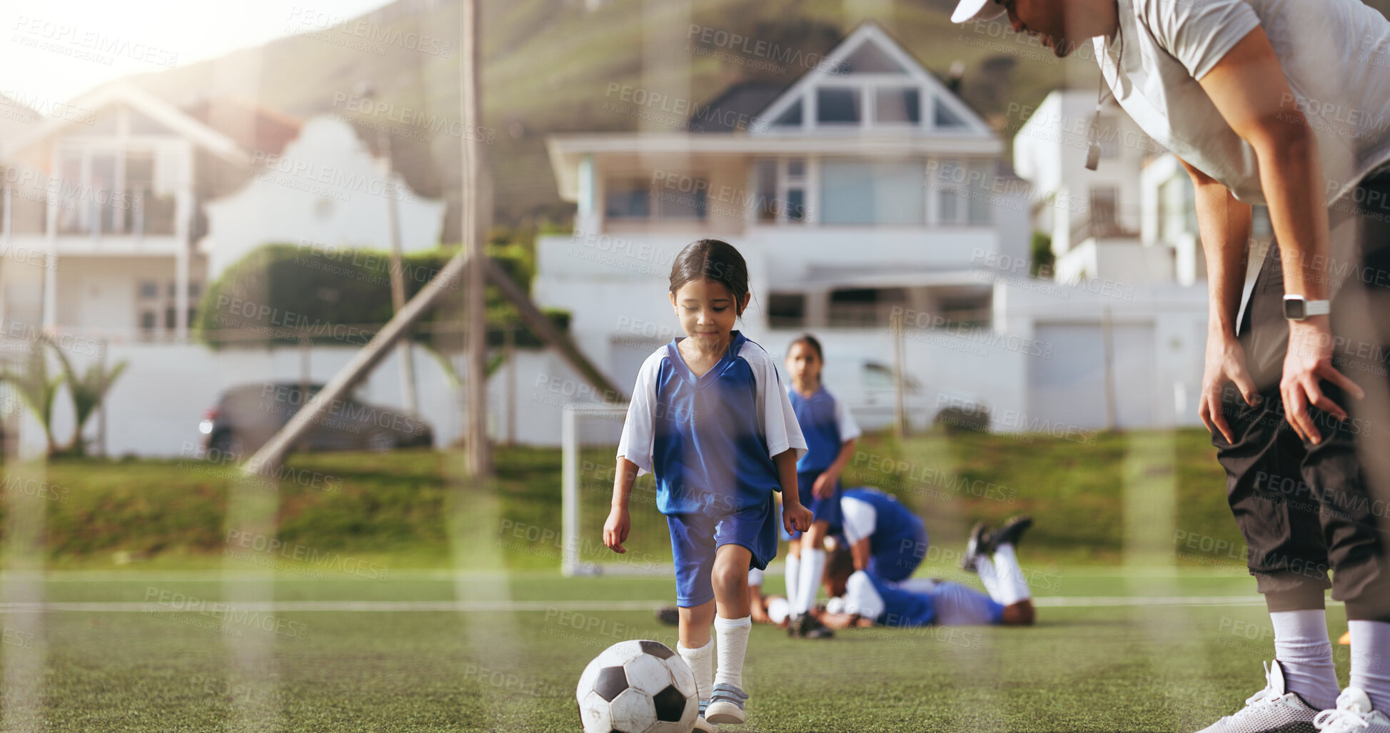 Buy stock photo Coach, help and child with soccer ball on field for sport, practice and game with aim by net. Man, girl kid and team with football match training for exercise, advice or ready for goal outdoor