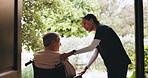 Wheelchair, window and caregiver with senior man for talking, medical service and assisted living. Healthcare, retirement home and nurse with elderly person with disability for care, help and support