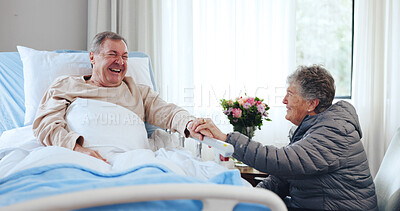 Buy stock photo Laugh, old couple and holding hands in hospital for support, funny conversation and visit for comfort. Smile, care and senior people with humor in medical clinic, talking and flowers for recovery