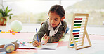 Child, student and writing with notebook in home for education, studying and maths homework. Girl, kid and sticky notes with stationery for learning, calculation solution and numeracy skills on floor