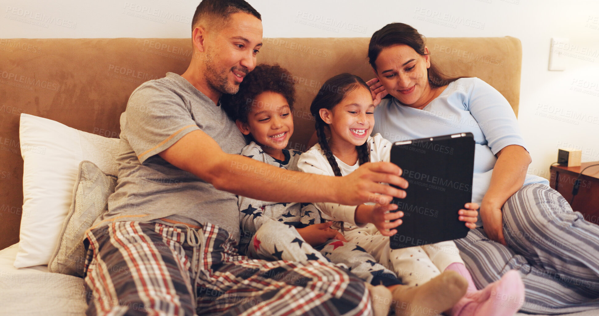 Buy stock photo Tablet, relax and family on bed in home with watching movie, film or series on app on weekend together. Happy, digital technology and parents with children streaming show online in bedroom at house.