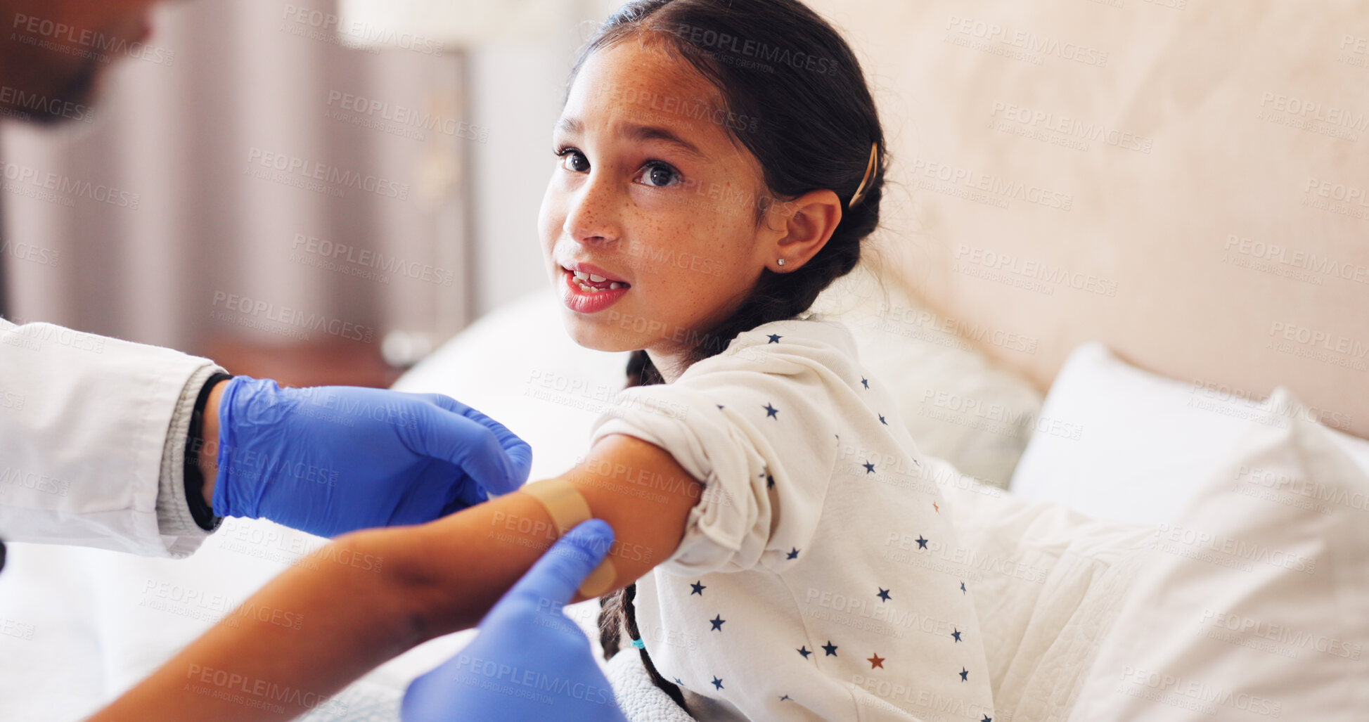 Buy stock photo Plaster, doctor and child in home with injury, accident or sore with first aid care at consultation. Help, checkup and medical pediatrician with girl kid for hurt arm with bandage in bedroom at house