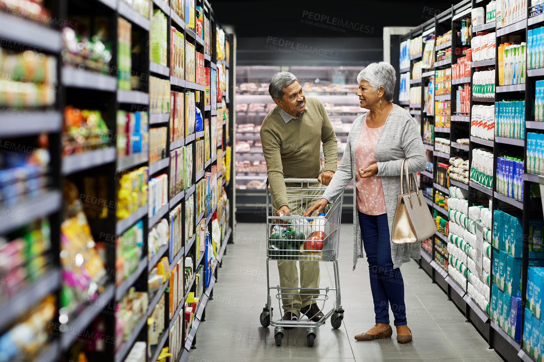 Buy stock photo Shot of a elderly couple grocery shopping in a supermarket
