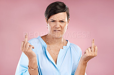 Buy stock photo Attitude, studio and portrait of woman with middle finger for conflict, rude opinion and rejection. Emoji, frustrated and person with gesture for anger, hate and protest with sign on pink background