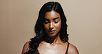 Makeup, beauty and Indian woman with cosmetics for grooming and salon treatment for hair care benefits. Space, person and thinking with cosmetology, glowing skin and hairstyle on studio background.