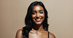 Portrait, skincare and happy woman in studio, shine and natural dermatology on brown background. Confidence, smile and person with beauty cosmetics for glow, wellness and self care for healthy skin