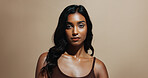 Portrait, skincare and woman in studio, confidence and natural dermatology on brown background space. Glow, healthy skin and serious person with beauty cosmetics for shine, wellness and cosmetology