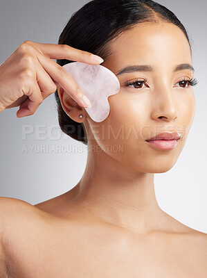 Buy stock photo Skincare, facelift or woman with gua sha, tool contour or massage in facial routine. Wellness, sculpting or female person with stone, lymphatic drainage or irritation reduction on studio background.