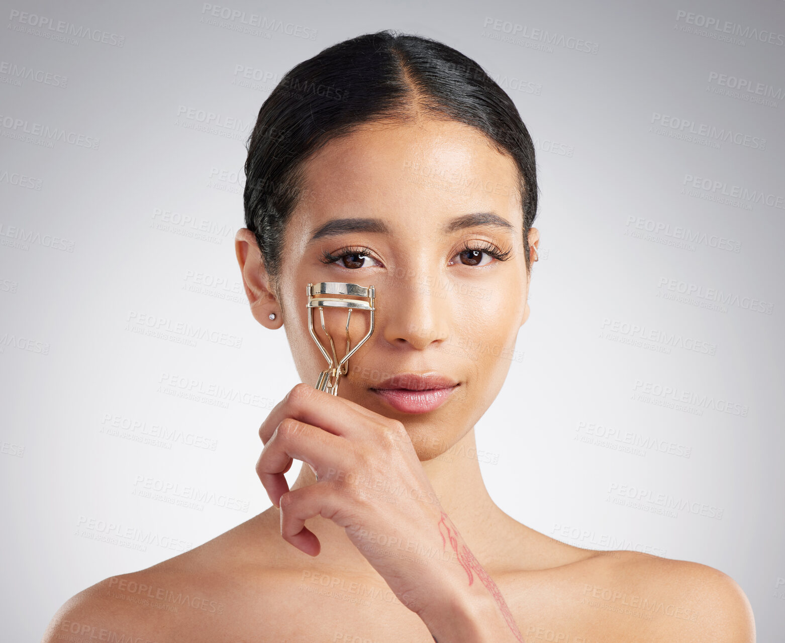 Buy stock photo Curling, eyelashes and portrait of woman in studio for makeover, routine or treatment. Aesthetic, extensions and skincare tool with confident person on white background for cosmetics or wellness