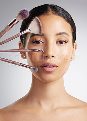 Buy stock photo Beauty, brushes and portrait of woman in studio for cosmetics, makeover or transformation. Makeup, recommend and variety with person on white background for change, facial aesthetic or foundation