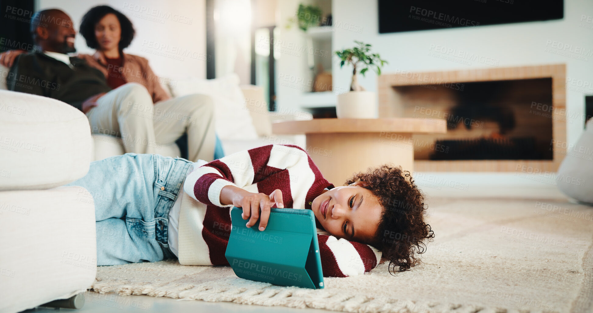 Buy stock photo Child, student and relax with tablet at house for research, reading ebook and education video. Parents, daughter and digital for elearning, browsing website and academic games for knowledge in lounge