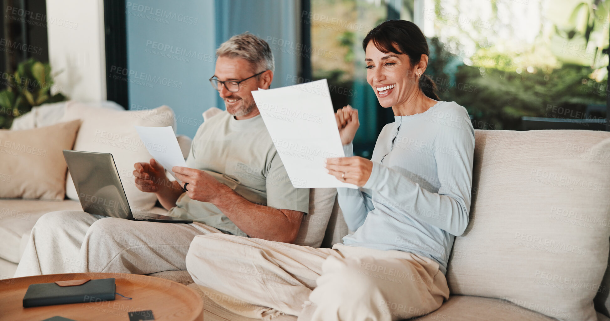 Buy stock photo Couple, documents and celebration with finance in home with revenue increase, success or goals in lounge. Mature people, fist pump and excited with budget review, investment and profit in living room