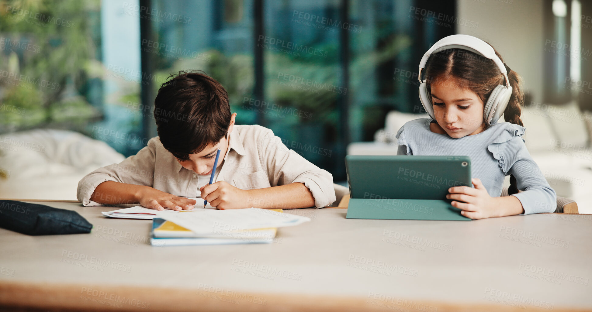 Buy stock photo Homework, headphones and children in home with tablet, activity and project or academic app. Homeschool, tech and siblings in kitchen with document, digital lesson or assessment in remote education