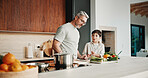 Child, learning and cooking with dad in kitchen, bonding and development of culinary skills in home. Family, together and teaching recipe to kid, mature person and meal preparation with boy in house