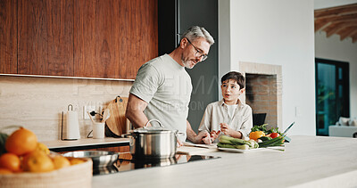 Buy stock photo Child, learning and cooking with dad in kitchen, bonding and development of culinary skills in home. Family, together and teaching recipe to kid, mature person and meal preparation with boy in house