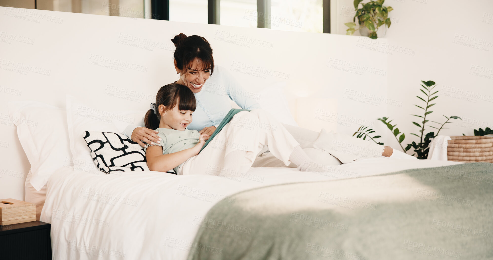 Buy stock photo Mother, child and bonding on bed with tablet, digital app and play knowledge game for development. Happy family, mom and daughter learning in home with tech, website or educational gaming for growth.