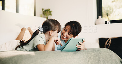 Buy stock photo Mother, daughter and laugh on bed with tablet, streaming funny movie and bonding together on weekend. Happy family, mom and child in home with tech, online entertainment and humor for kids cartoon.