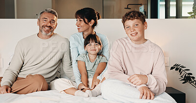 Buy stock photo Family, care and relax in bedroom, smile or connection together on weekend break with children. Mother, father and kids at home for love, portrait or support for development with happy parents