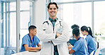 Crossed arms, meeting and portrait of doctor in hospital for medical support, health service and help. Healthcare, clinic and man with confidence, pride and about us for career, job and surgery plan