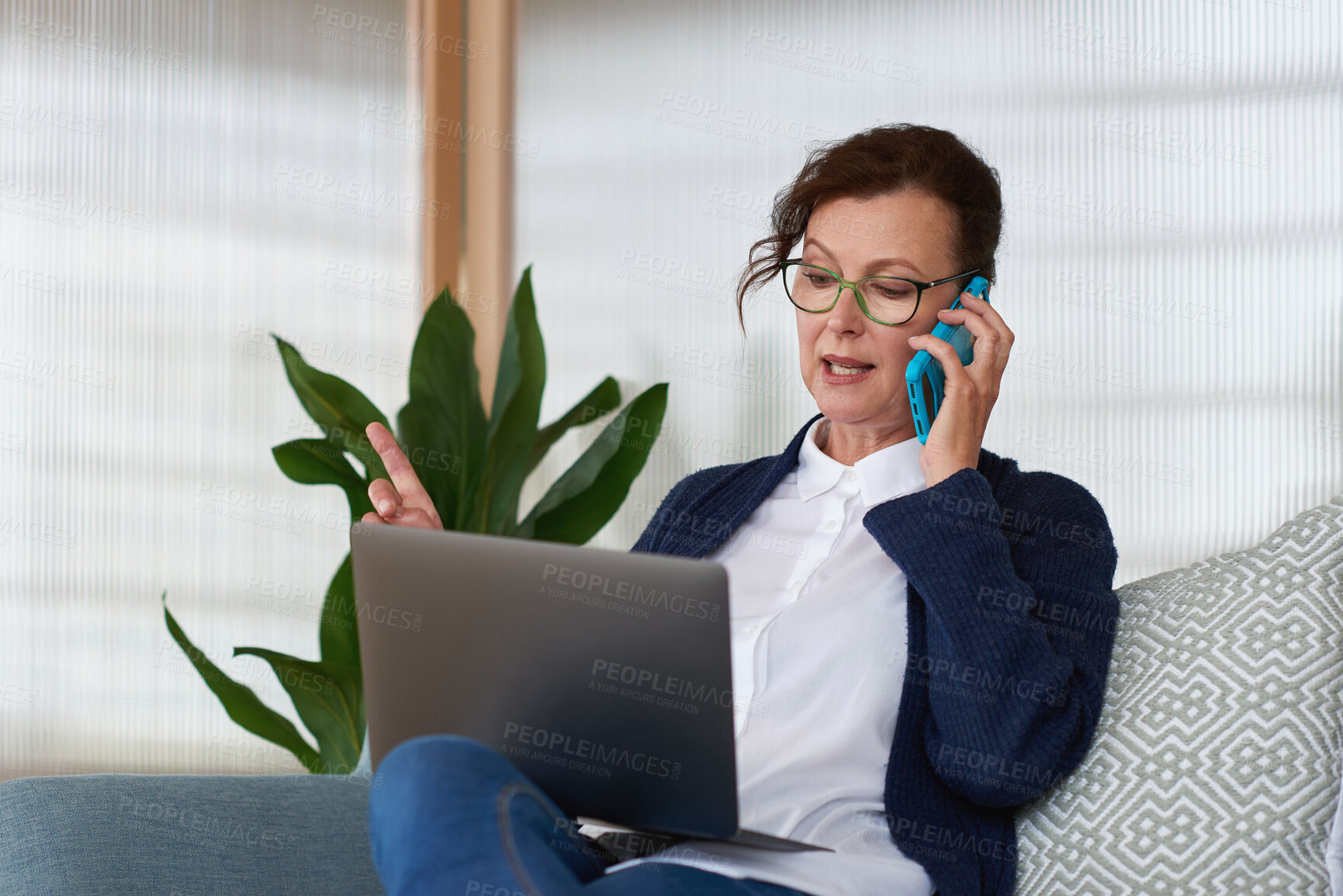 Buy stock photo Woman, laptop and phone call on sofa for remote work from home, glasses or discussion in living room. Mature person, virtual assistant and computer with insight, problem solving and feedback at house