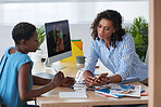 Business woman meeting client in office sharing creative ideas looking at photos